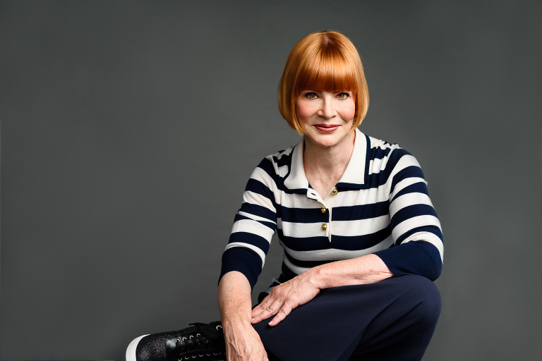 Portrait of Kathleen Dockry, Strategist and Coach on gray background