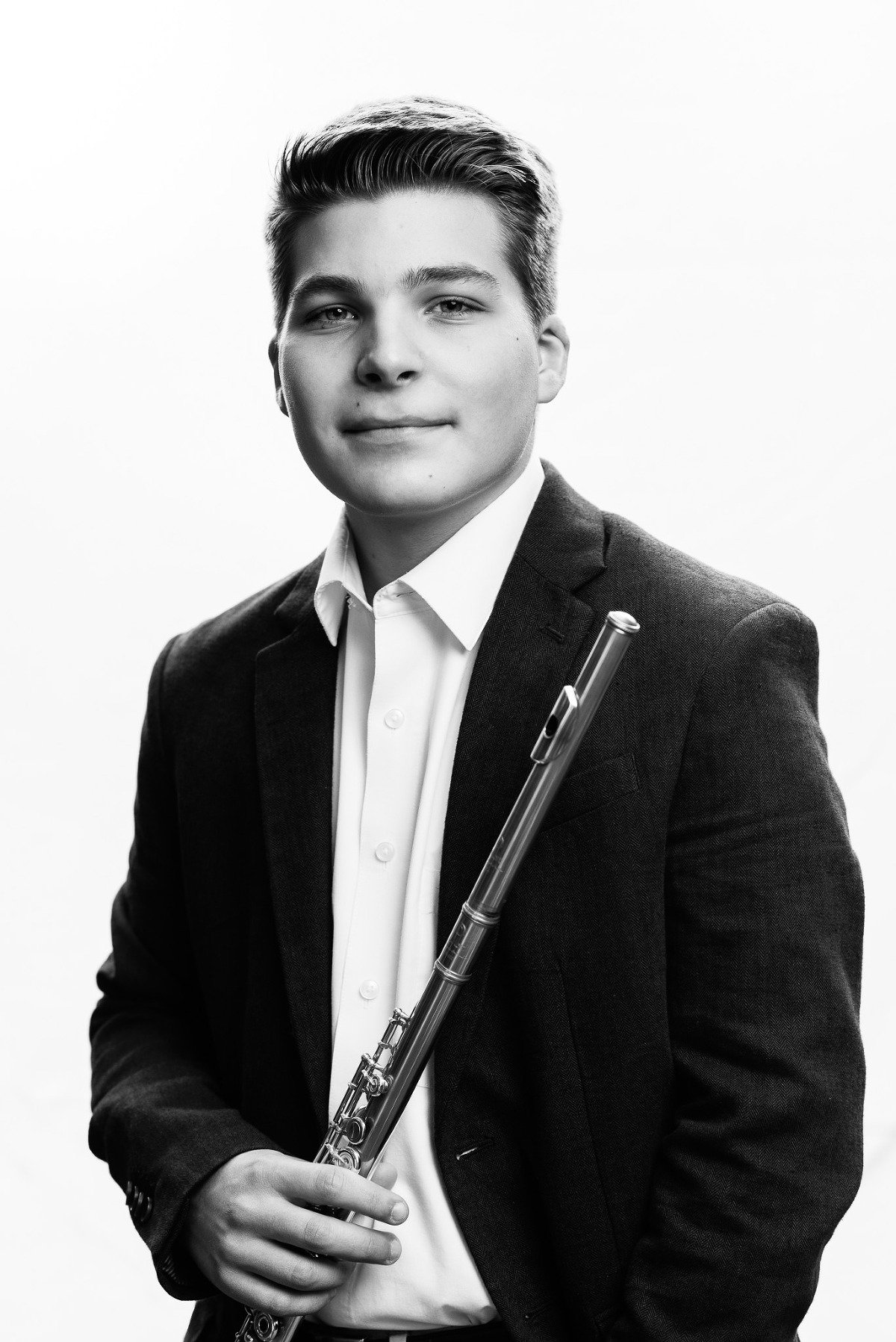 Young musician with flute against white background
