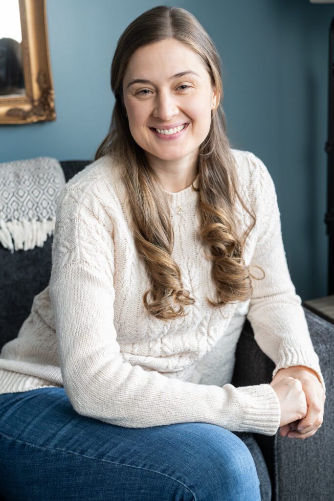 A therapist at Ellie Mental Health Falmouth in a relaxed, candid headshot inside the clinic