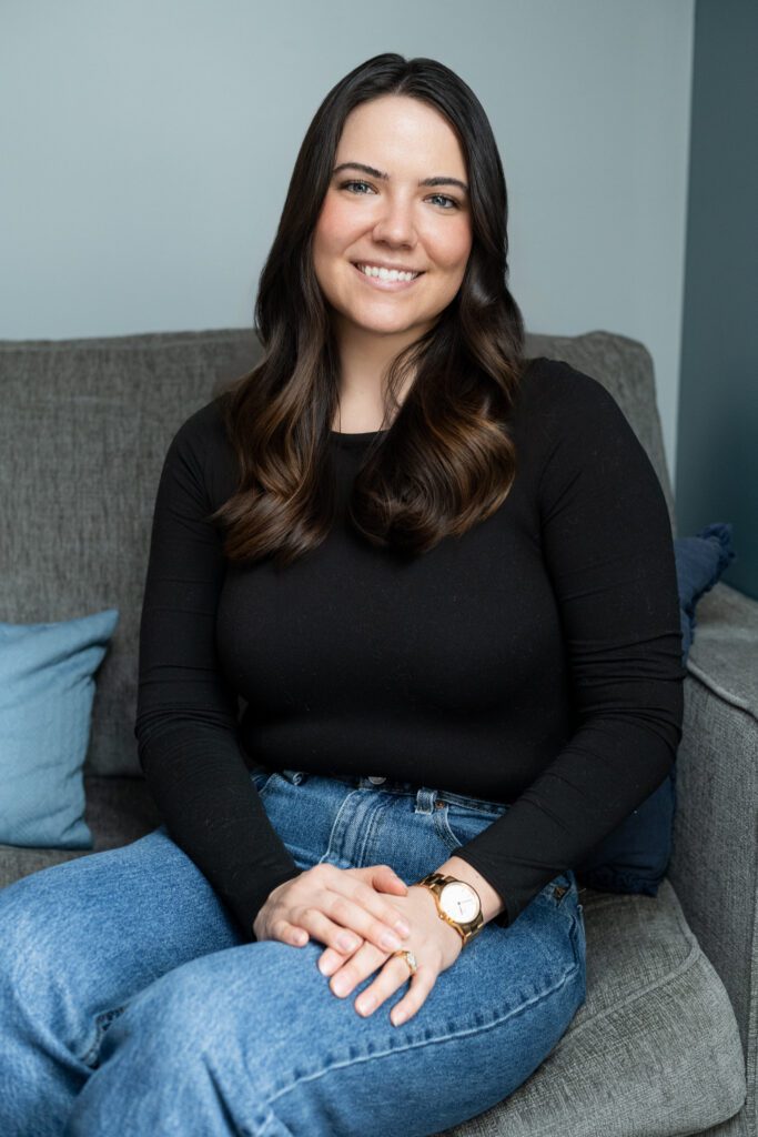 A therapist at Ellie Mental Health Falmouth in a relaxed, candid headshot inside the clinic