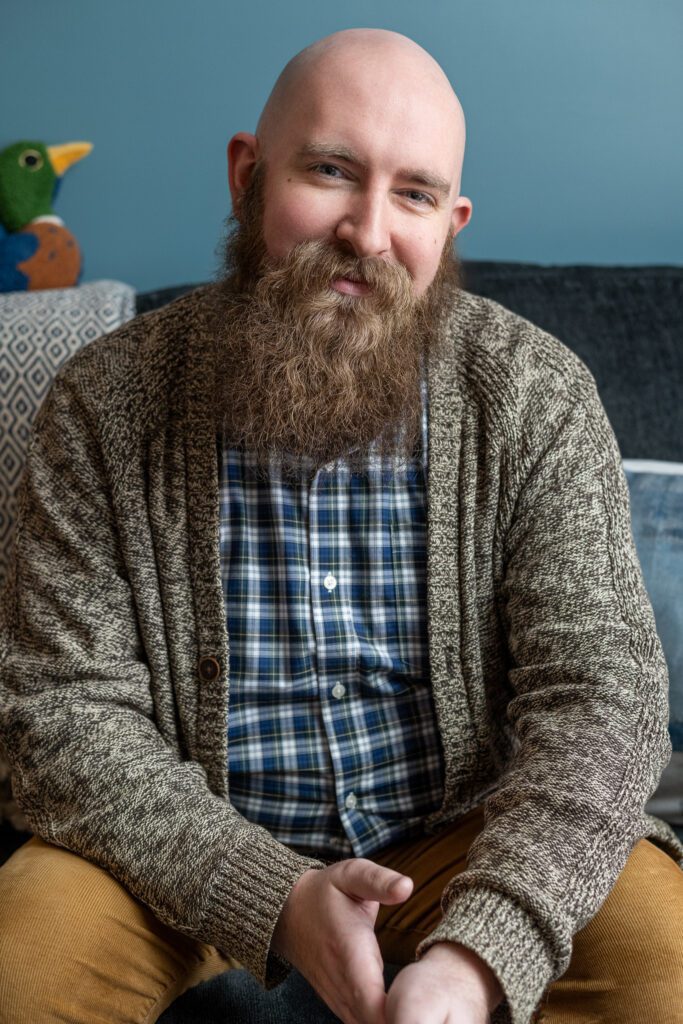 A therapist at Ellie Mental Health Falmouth in a relaxed, candid headshot inside the clinic